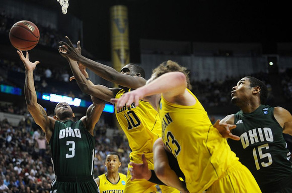 Trey Burke (3), Tim Hardaway Jr. (10), and Evan Smotrycz (23)