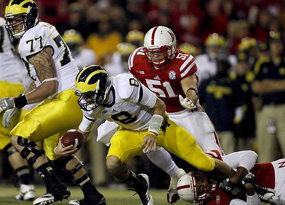 Taylor Lewan (77) and Russell Bellomy (8)