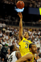 Trey Burke (3) and Jon Horford (15)