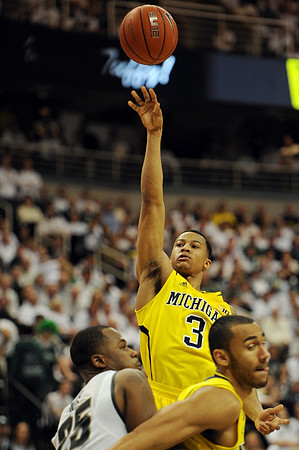 Trey Burke (3) and Jon Horford (15)