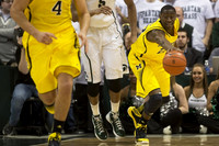 Mitch McGary (4) and Caris LeVert (23)
