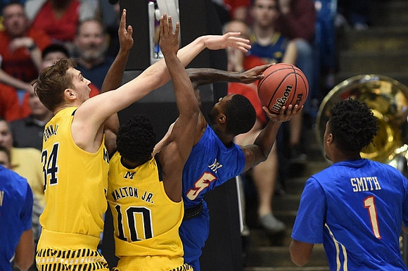 Mark Donnal (34) and Derrick Walton Jr. (10)