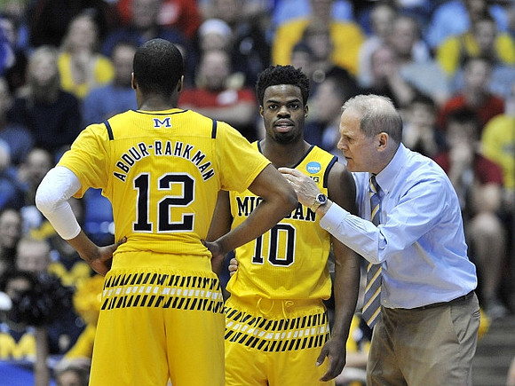 Muhammad-Ali Abdur-Rahkman (12), Derrick Walton Jr. (10), and John Beilein