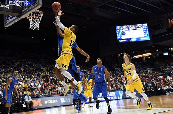 Muhammad-Ali Abdur-Rahkman (12), Derrick Walton Jr. (10), and Mark Donnal (34)