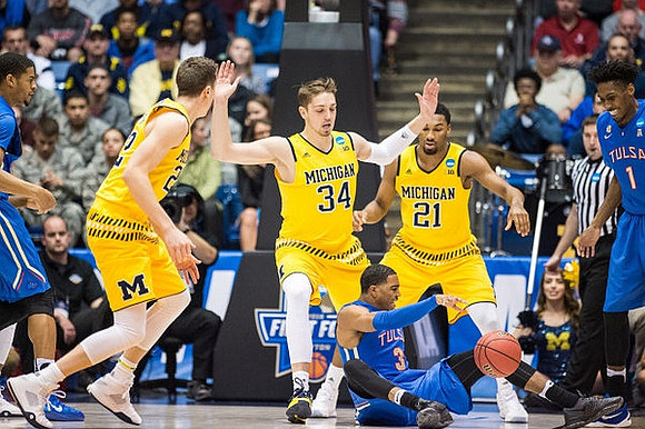 Duncan Robinson (22), Mark Donnal (34), and Zak Irvin (21)