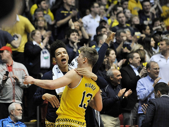 Moritz Wagner (13) and D.J. Wilson (5)