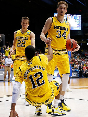 John Beilein, Duncan Robinson (22), Muhammad-Ali Abdur-Rahkman (12), and Mark Donnal (34)