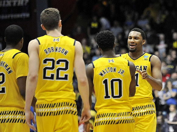 Muhammad-Ali Abdur-Rahkman (12), Duncan Robinson (22), Derrick Walton Jr. (10), and Zak Irvin (21)