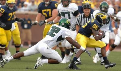 Mario Manningham, Alex Mitchell, and Adam Kraus