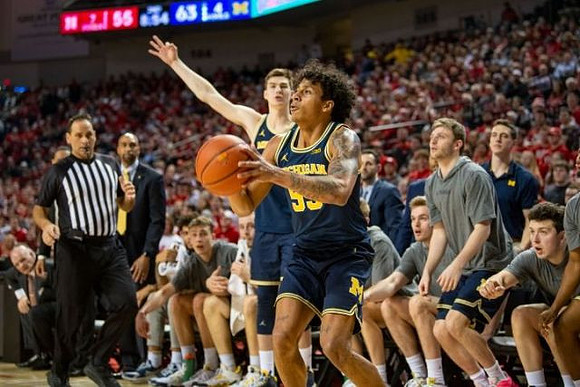 Eli Brooks (55) and Michigan Team