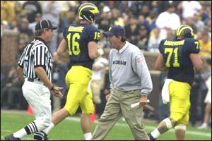 Lloyd Carr, John Navarre (16) and  Kurt Anderson (71)
