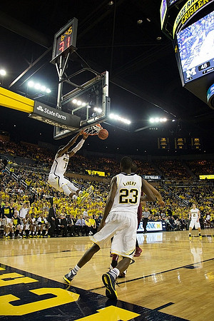 Glenn Robinson III (1), Caris LeVert (23), and Spike Albrecht (2)