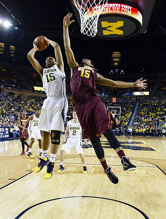 Jon Horford (15), Zak Irvin (21), and Spike Albrecht (2)