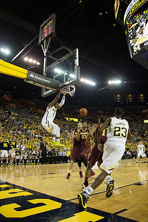 Glenn Robinson III (1), Caris LeVert (23), and Spike Albrecht (2)