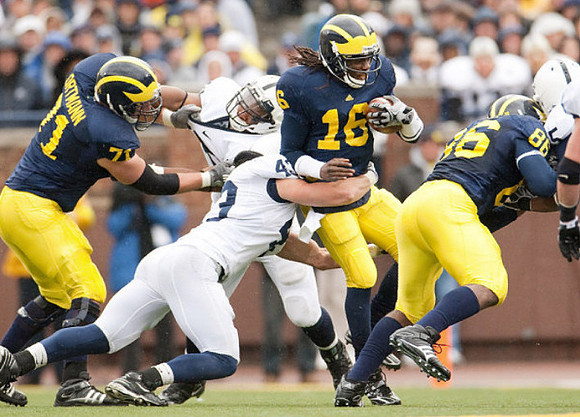 Mark Ortmann (71), Denard Robinson (16), and Kevin Koger (86)