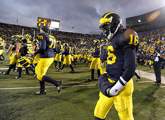 Bryant Nowicki (70) and Denard Robinson (16)