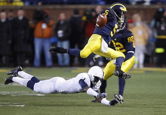 Tate Forcier (5) and LaTerryal Savoy (82)