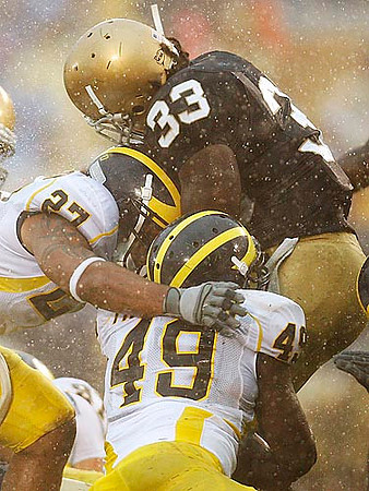 Brandon Harrison (27) and John Thompson (49)