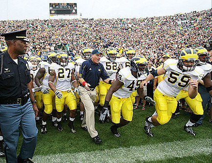 Brandon Harrison (27), Rich Rodriguez, Stephen Schilling (52), Obi Ezeh (45), and Sean Griffin (59)