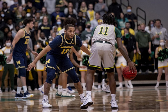Brandon Johns Jr. (23) and DeVante' Jones (12)