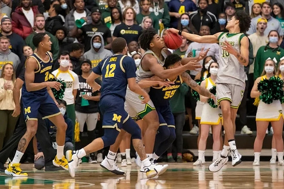 Kobe Bufkin (2), DeVante' Jones (12), and Eli Brooks (55)