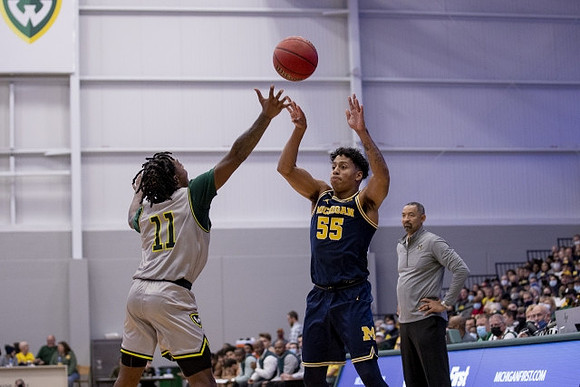 Eli Brooks (55) and Juwan Howard