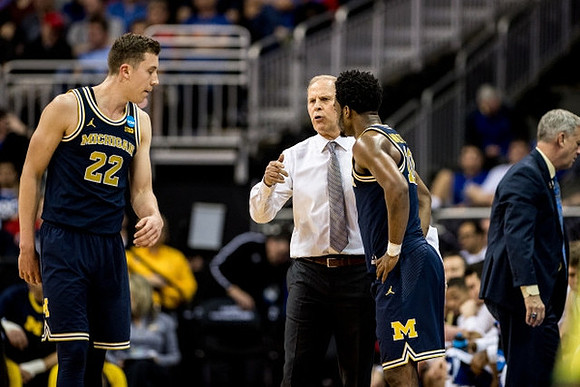 Duncan Robinson (22), John Beilein, Derrick Walton Jr. (10), and Jeff Meyer