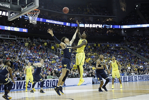 Xavier Simpson (3), Duncan Robinson (22), D.J. Wilson (5), and Zak Irvin (21)