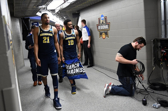 Zak Irvin (21) and Derrick Walton Jr. (10)