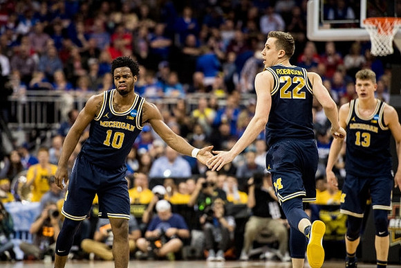 Derrick Walton Jr. (10), Duncan Robinson (22), and Moritz Wagner (13)