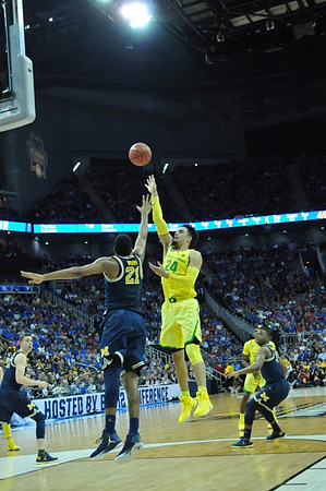 Duncan Robinson (22), Zak Irvin (21), and Xavier Simpson (3)