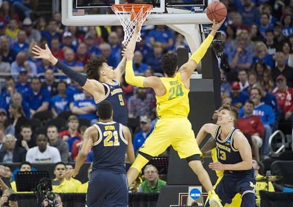 Zak Irvin (21), D.J. Wilson (5), and Moritz Wagner (13)