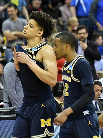 D.J. Wilson (5) and Muhammad-Ali Abdur-Rahkman (12)