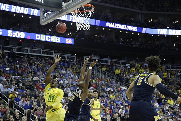 Derrick Walton Jr. (10), Muhammad-Ali Abdur-Rahkman (12), and D.J. Wilson (5)