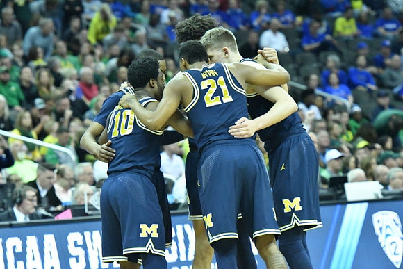 Muhammad-Ali Abdur-Rahkman (12), Derrick Walton Jr. (10), D.J. Wilson (5), Zak Irvin (21), and Moritz Wagner (13)