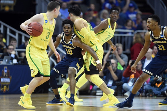 Derrick Walton Jr. (10) and Zak Irvin (21)