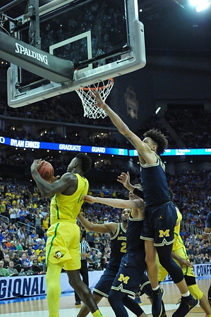 Zak Irvin (21), Duncan Robinson (22), and D.J. Wilson (5)