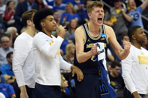 Mark Donnal (34), Ibi Watson (23), Moritz Wagner (13), and Xavier Simpson (3)
