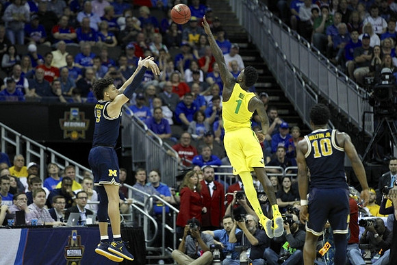 D.J. Wilson (5) and Derrick Walton Jr. (10)
