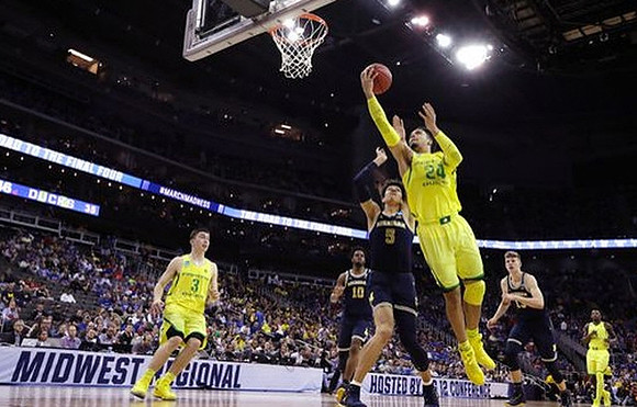 Derrick Walton Jr. (10), D.J. Wilson (5), and Moritz Wagner (13)