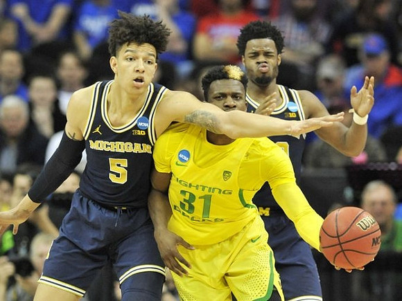 D.J. Wilson (5) and Derrick Walton Jr. (10)
