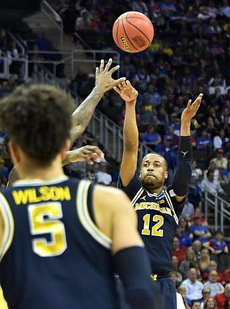 D.J. Wilson (5) and Muhammad-Ali Abdur-Rahkman (12)