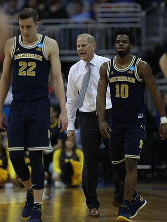 Duncan Robinson (22), John Beilein, and Derrick Walton Jr. (10)