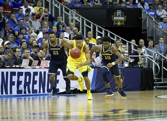 Zak Irvin (21) and Derrick Walton Jr. (10)