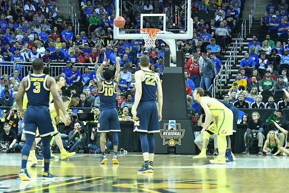 Xavier Simpson (3), Derrick Walton Jr. (10), and Duncan Robinson (22)
