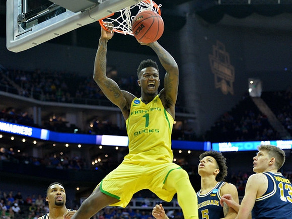 Zak Irvin (21), D.J. Wilson (5), and Moritz Wagner (13)