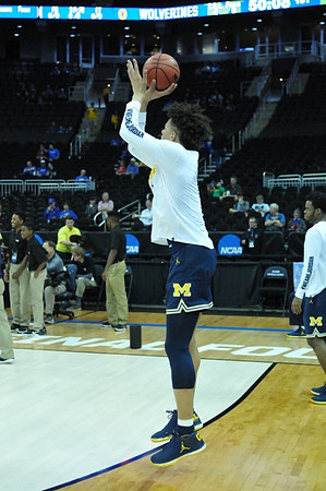 D.J. Wilson (5) and Derrick Walton Jr. (10)