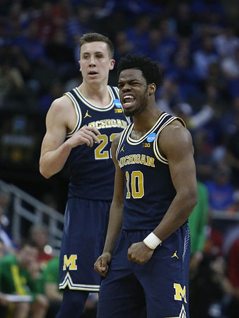 Duncan Robinson (22) and Derrick Walton Jr. (10)