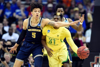 D.J. Wilson (5) and Derrick Walton Jr. (10)