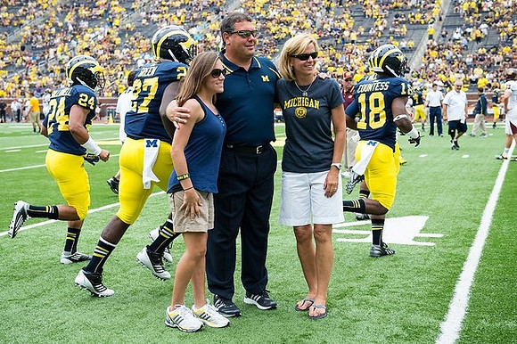 Brady Hoke, Delonte Hollowell (24), Derrick Green (27), and Blake Countess (18)